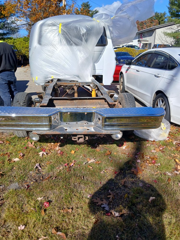 Truck chassis with cab wrapped in plastic for paint prep