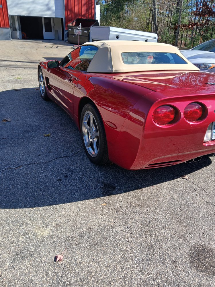 Red Corvette convertible rear three-quarter view